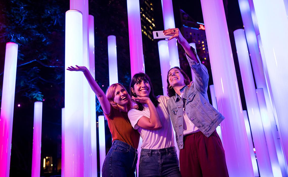 Vivid Sydney 2019 Friends enjoying the Triangulum light installation in East Circular Quay during Vivid Sydney 2019